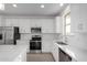 Modern kitchen with stainless steel appliances, white cabinets, and subway tile backsplash at 9042 N 116Th Ln, Youngtown, AZ 85363