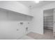A clean laundry room with a sink and built-in shelving units at 9042 N 116Th Ln, Youngtown, AZ 85363