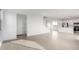 Open floor plan featuring tile flooring, staircase, and view to a bright kitchen at 9042 N 116Th Ln, Youngtown, AZ 85363