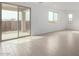 Sun-drenched living room with sliding doors to the patio and views of the neighborhood at 9042 N 116Th Ln, Youngtown, AZ 85363
