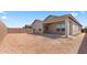 Spacious backyard with block fence, and patio area at 16620 N Dante Way, Maricopa, AZ 85138