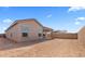 Backyard showcasing stucco exterior and covered patio at 16620 N Dante Way, Maricopa, AZ 85138