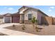 Charming single-story home featuring a two-car garage and desert landscaping for low maintenance appeal at 16620 N Dante Way, Maricopa, AZ 85138