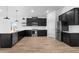 Modern kitchen with dark cabinets, stainless steel appliances, white subway tile backsplash, and wood-look flooring at 16620 N Dante Way, Maricopa, AZ 85138