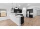 Bright, modern kitchen with sleek dark cabinetry, stainless steel appliances, and a stylish breakfast bar at 16620 N Dante Way, Maricopa, AZ 85138