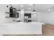 Elegant kitchen featuring a white quartz countertop island, dark cabinets, and stainless steel appliances at 16620 N Dante Way, Maricopa, AZ 85138