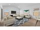 Open-concept living room with contemporary furnishings, wood-look floors, and ample natural light at 16620 N Dante Way, Maricopa, AZ 85138