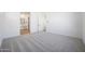 Spacious bedroom with neutral carpeting, featuring doorway into a bathroom at 28266 N 134Th Dr, Peoria, AZ 85383