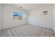 Bright bedroom featuring neutral carpeting, complemented by dual windows for natural light at 28266 N 134Th Dr, Peoria, AZ 85383