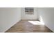 Bright bedroom with wood-style tile flooring and a large window offering natural light at 28266 N 134Th Dr, Peoria, AZ 85383