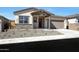 Charming single-story home featuring a desert landscaped yard and a covered front porch at 28266 N 134Th Dr, Peoria, AZ 85383
