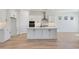 Bright and airy kitchen with white cabinets, sleek hardware, and a center island at 28266 N 134Th Dr, Peoria, AZ 85383