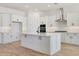 Bright kitchen featuring white cabinets, stainless steel appliances, and large center island at 28266 N 134Th Dr, Peoria, AZ 85383