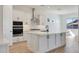 Modern kitchen with white cabinets, stainless steel appliances, and a large center island at 28266 N 134Th Dr, Peoria, AZ 85383