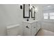 This bathroom has a double sink vanity with modern fixtures and lighting at 16610 N Dante Way, Maricopa, AZ 85138