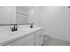 Modern bathroom with double sinks, white cabinetry, and sleek black fixtures at 16610 N Dante Way, Maricopa, AZ 85138