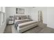 This staged bedroom has a large, comfortable bed with end tables at 16610 N Dante Way, Maricopa, AZ 85138