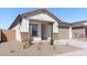 Single-story home with stone accents, a tile roof, and a well-maintained front yard at 16610 N Dante Way, Maricopa, AZ 85138