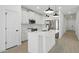 Bright kitchen featuring white cabinets, stainless steel appliances, an island, and modern lighting at 16610 N Dante Way, Maricopa, AZ 85138