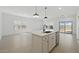 Open-concept kitchen with an island, stainless steel appliances, and access to the dining and living areas at 16610 N Dante Way, Maricopa, AZ 85138