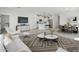 Open-concept living area featuring modern decor, a sleek kitchen, and a cozy dining space at 16610 N Dante Way, Maricopa, AZ 85138