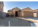 Tan house with a two-car garage and red front door at 23235 W Florence Ave, Buckeye, AZ 85326