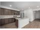 Open concept kitchen with island and stainless steel appliances at 23235 W Florence Ave, Buckeye, AZ 85326