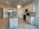 Bright kitchen showcases white cabinets, stainless steel appliances and granite countertops at 25243 W Bowker St, Buckeye, AZ 85326