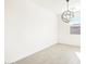 Bright living room featuring modern light fixture and wood-look tile flooring at 8613 W Warner St, Tolleson, AZ 85353