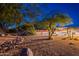 Expansive backyard features desert landscape, mature trees, a serene pool, and comfortable seating for outdoor entertaining at 13108 N 76Th St, Scottsdale, AZ 85260
