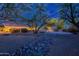 Wide backyard with desert landscape, mature trees and a rock-lined creek bed create a serene outdoor space at 13108 N 76Th St, Scottsdale, AZ 85260