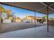 View from the covered patio of the home and backyard, showing the generous landscaping and ample parking space at 13108 N 76Th St, Scottsdale, AZ 85260