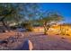 Expansive backyard with desert landscape, mature trees, a tranquil pool and seating for outdoor entertaining at 13108 N 76Th St, Scottsdale, AZ 85260