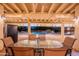 A covered patio boasts a dining area overlooking a refreshing pool and landscaped backyard at 13108 N 76Th St, Scottsdale, AZ 85260
