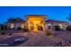 Charming home featuring a desert landscape, covered entry and a red tile roof, illuminated in the evening at 13108 N 76Th St, Scottsdale, AZ 85260