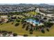 Aerial view of community pool with palm trees, lounge chairs, and mountain views at 22446 E Russet Rd, Queen Creek, AZ 85142