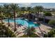 Aerial shot of a community pool with lounge seating, palm trees, and shade structures at 22446 E Russet Rd, Queen Creek, AZ 85142