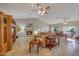 Open-concept living room featuring a fireplace, large windows, and tile flooring at 3935 N 151St Ave, Goodyear, AZ 85395