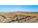 Expansive aerial view of a residential community showcases mountain views and modern homes with solar panels at 4102 S 186Th Ave, Goodyear, AZ 85338
