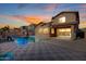 Inviting backyard pool and spa, set in a stone paver patio, is perfect for outdoor entertaining at 4102 S 186Th Ave, Goodyear, AZ 85338