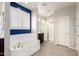 Bright bathroom featuring a soaking tub, a glass enclosed shower, and modern fixtures at 4102 S 186Th Ave, Goodyear, AZ 85338