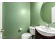 Compact powder room with a round mirror and a modern sink and vanity at 4102 S 186Th Ave, Goodyear, AZ 85338