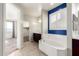 Bathroom with a soaking tub next to a window with modern fixtures and a shower at 4102 S 186Th Ave, Goodyear, AZ 85338