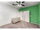 Bedroom showcasing modern green wall, ample storage with dresser and ceiling fan at 4102 S 186Th Ave, Goodyear, AZ 85338