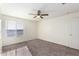 Bright bedroom with a ceiling fan, window and plush carpet, ready for personalization at 4102 S 186Th Ave, Goodyear, AZ 85338