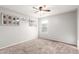 Calm bedroom with plush carpet, neutral walls, natural light, and a ceiling fan at 4102 S 186Th Ave, Goodyear, AZ 85338