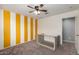 Bright bedroom featuring ceiling fan, an accent wall, and a closet at 4102 S 186Th Ave, Goodyear, AZ 85338