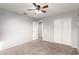Spacious bedroom with plush carpet, neutral walls, ceiling fan, and closet at 4102 S 186Th Ave, Goodyear, AZ 85338