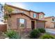Two-story stucco home boasting a stone-accented facade, tile roof, and desert landscaping at 4102 S 186Th Ave, Goodyear, AZ 85338