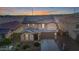 Charming two-story home with tile roof and a manicured front yard at 4102 S 186Th Ave, Goodyear, AZ 85338